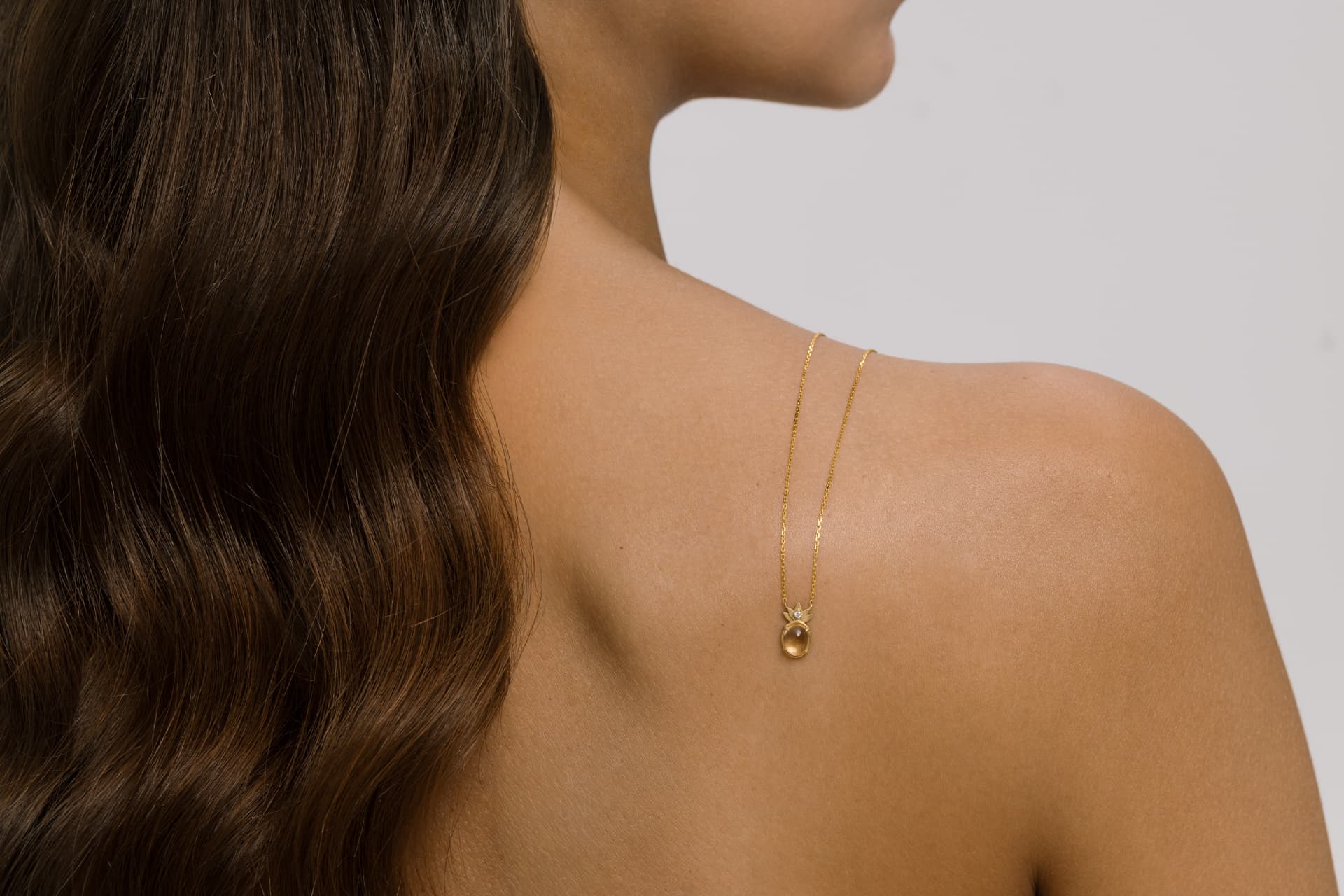 Hands cradling the THALYRA necklace