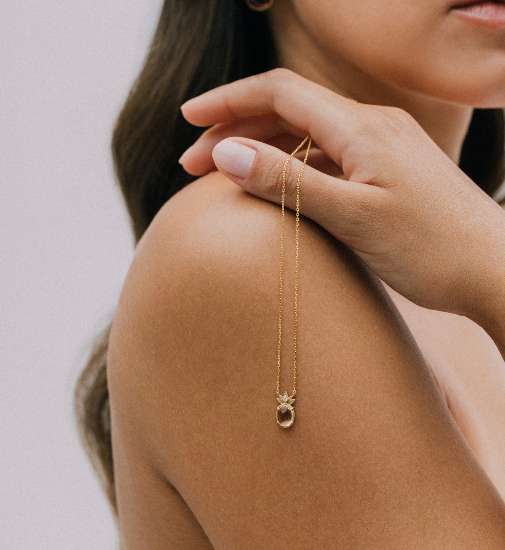 THALYRA pendant worn at the collarbone